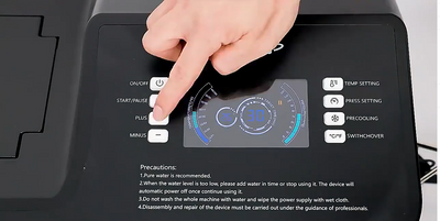 Hand pressing a button on a black appliance with digital display