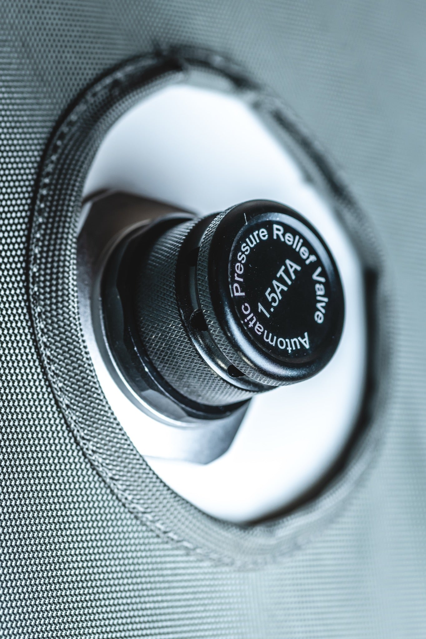 Close-up of an AIRVIDA 1.5 ATA automatic pressure relief valve securely mounted on the textured exterior of a soft-shell hyperbaric chamber.