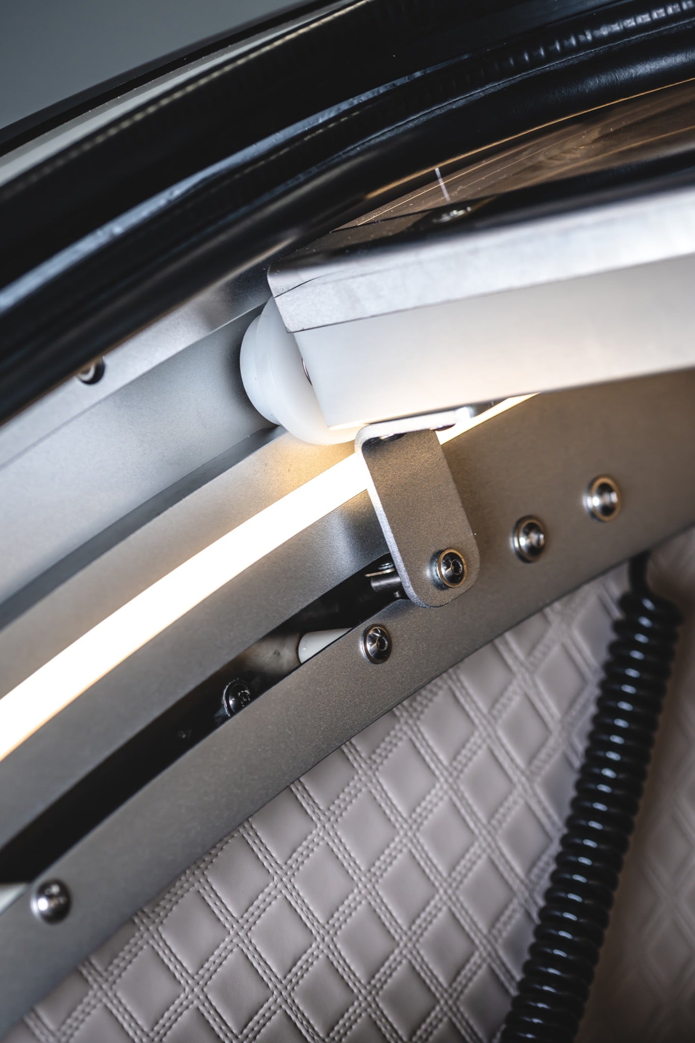 Close-up of the interior frame, lighting, and mechanical components of a hard-shell hyperbaric chamber.