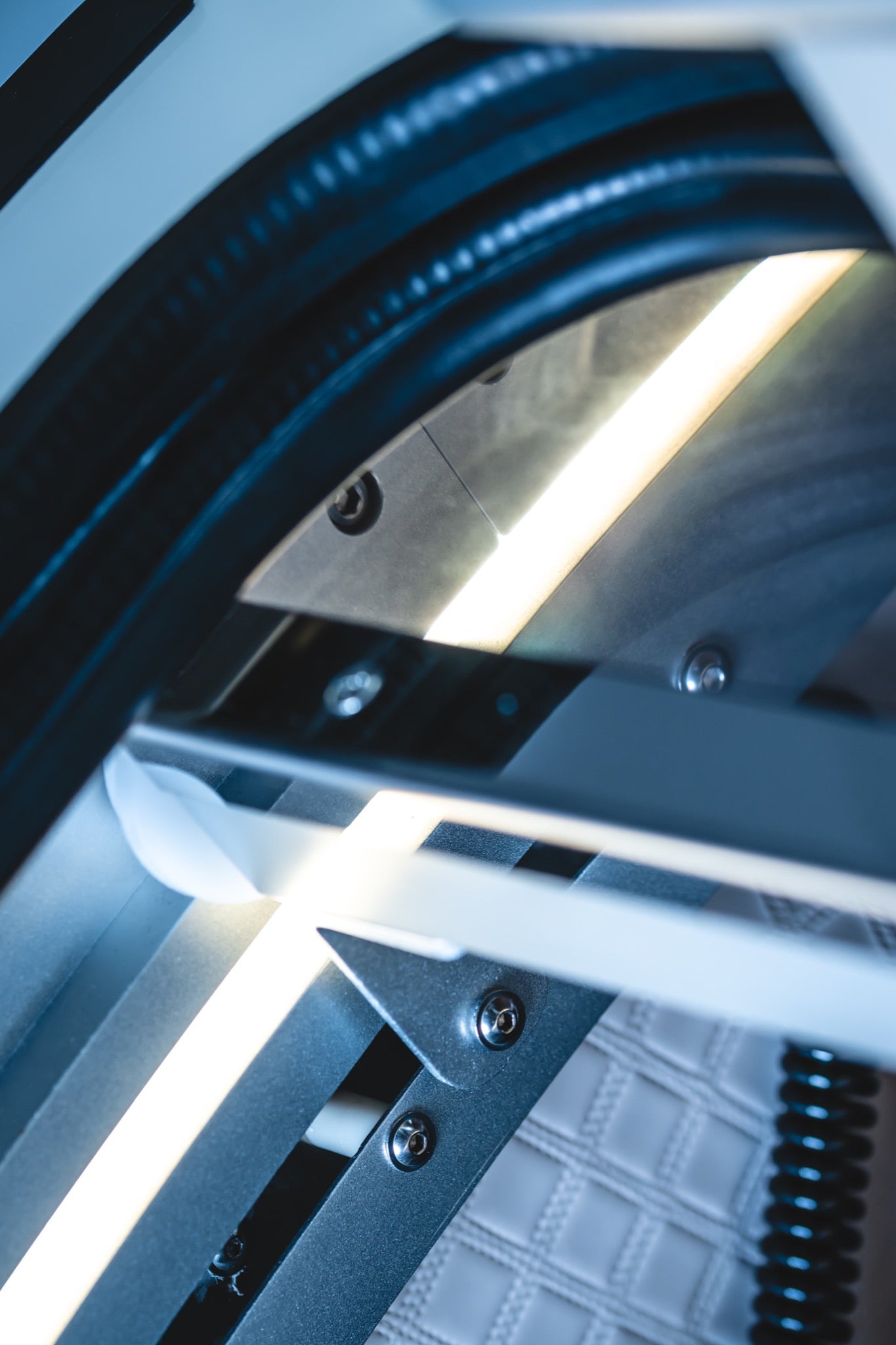Close-up of illuminated interior lighting and structural components inside a hard-shell hyperbaric chamber.