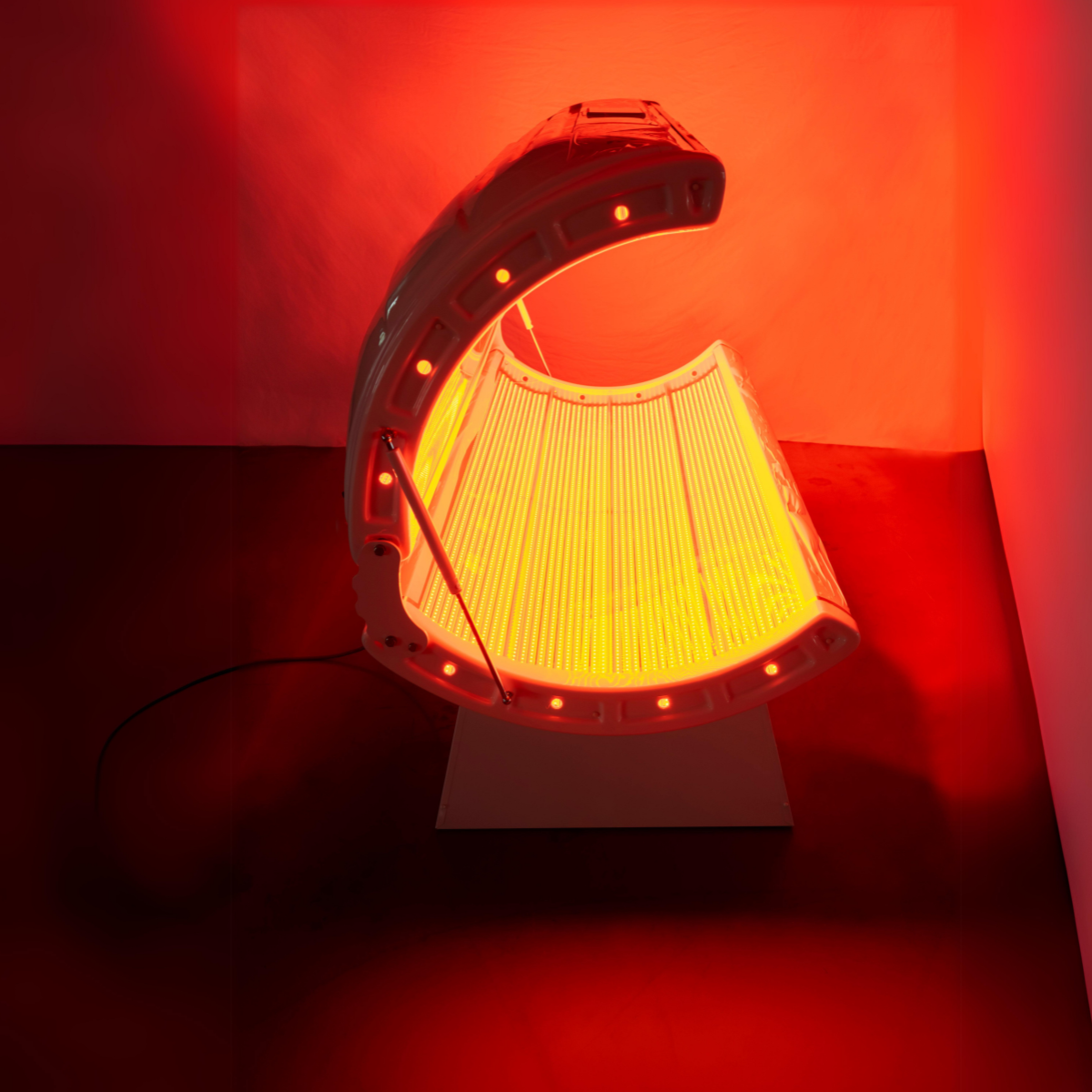 Red light therapy bed with curved LED panel for full-body infrared treatment