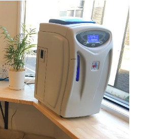 The Airvida Hydrogen Inhalation Machine H2JI1 on a wooden desk near a window.