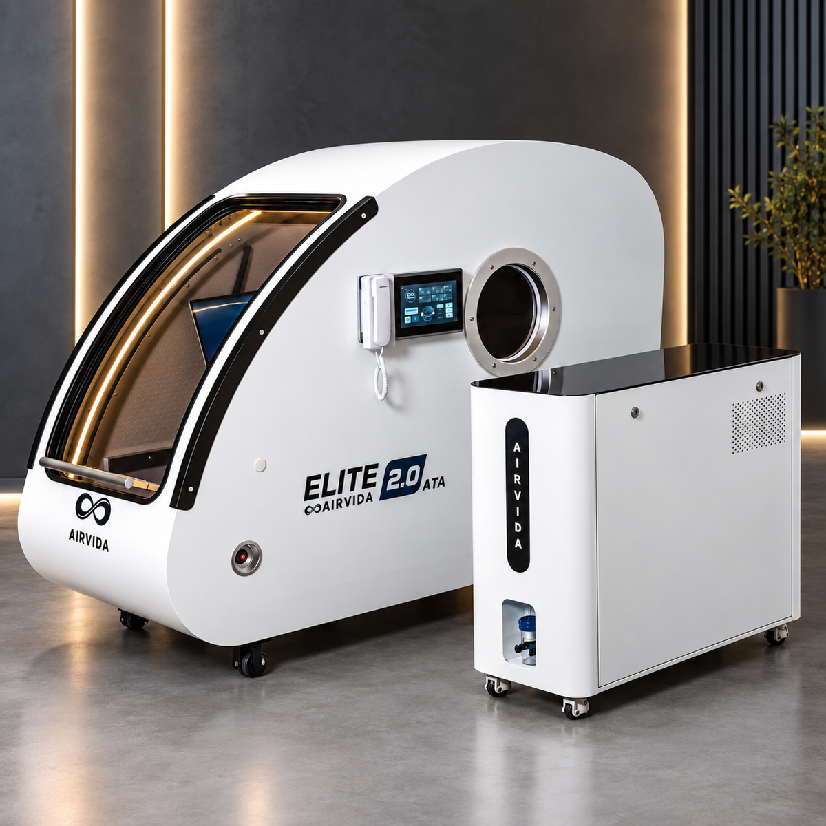 White Airvida Elite 2.0 ATA hyperbaric chamber with touchscreen and matching oxygen unit on wheels, displayed in a sleek wellness room with warm accent lighting.