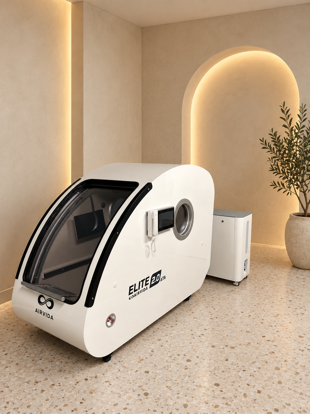 White Airvida Elite 2.0 ATA hyperbaric chamber with oxygen system displayed in a serene wellness room with warm arched lighting, neutral decor and a plant.