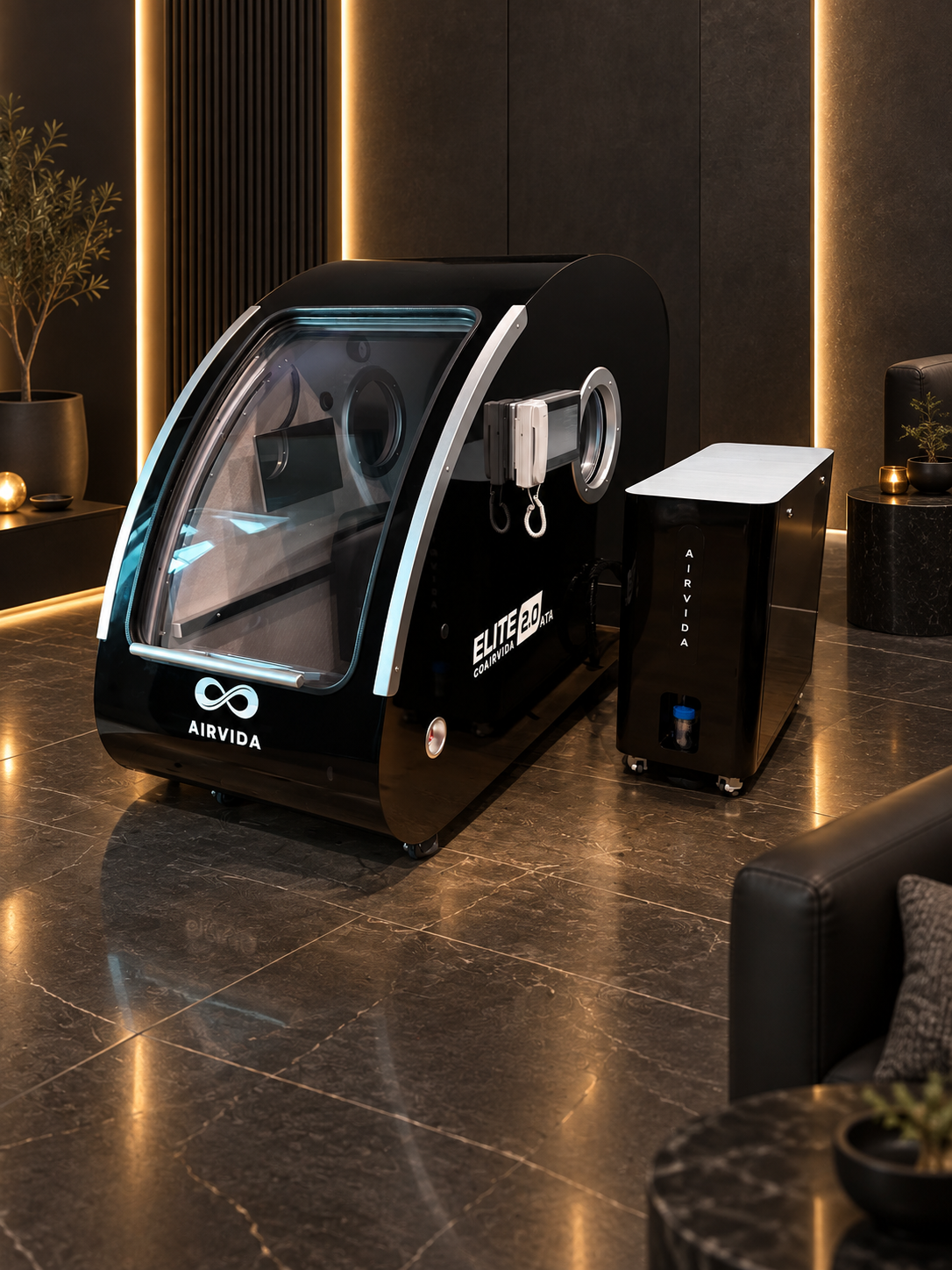 Black Airvida Elite 2.0 ATA hyperbaric chamber with oxygen system in a luxury wellness room featuring dark marble floors, warm lighting and modern decor.