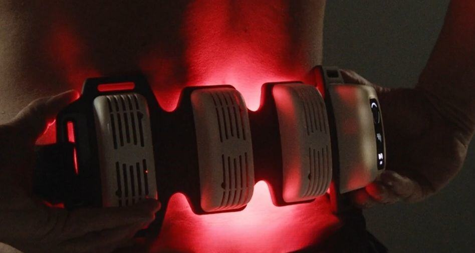 Close-up of a FlexBeam Portable Red Light Therapy Device with multiple components on a dark background