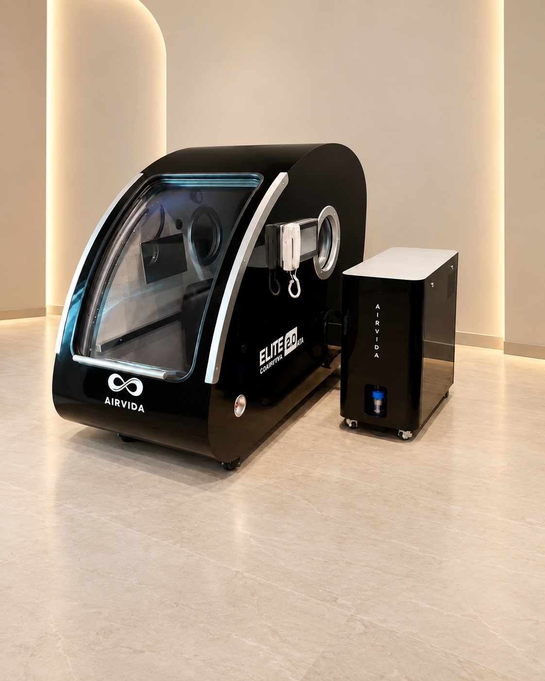 Black Airvida Elite 2.0 hyperbaric chamber with matching oxygen system displayed in a modern wellness room with warm lighting, clear door, and controls.