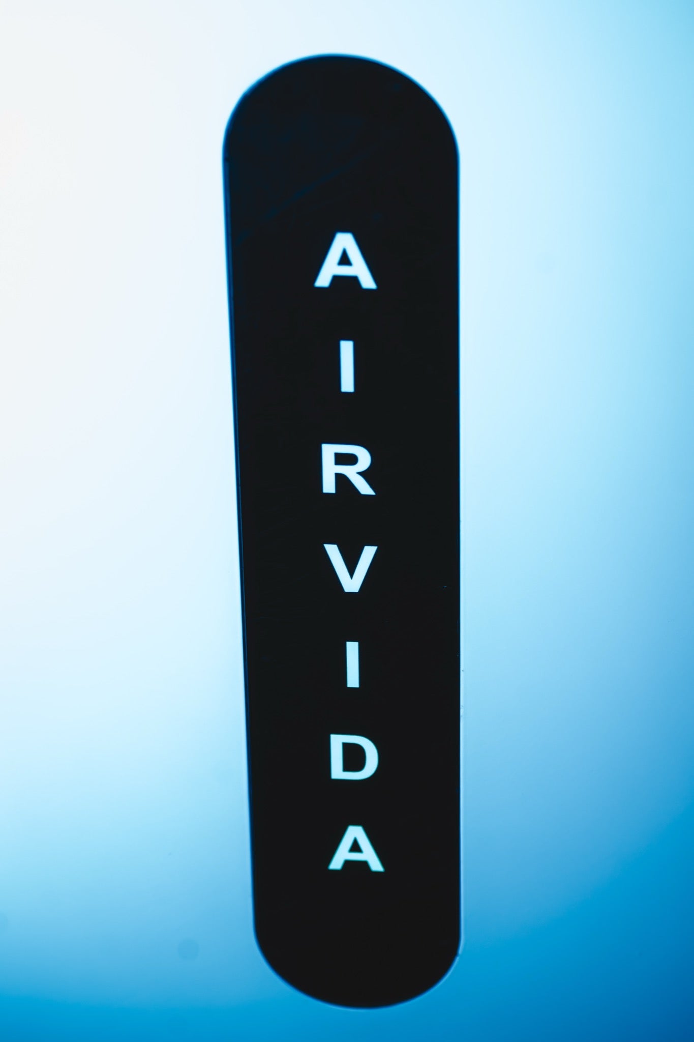 Close-up of the illuminated Airvida logo panel on a hyperbaric oxygen system unit.