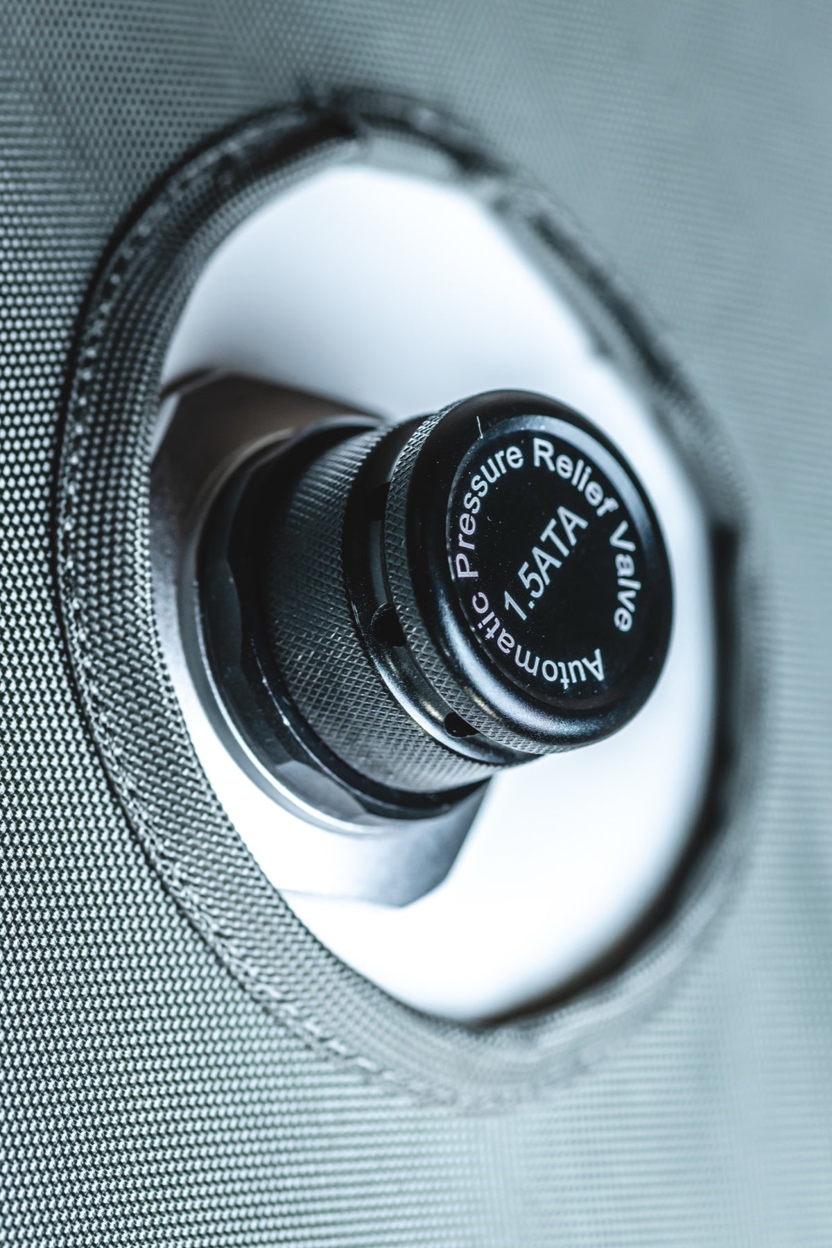 Close-up of an AIRVIDA 1.5 ATA automatic pressure relief valve securely mounted on the textured exterior of a soft-shell hyperbaric chamber.