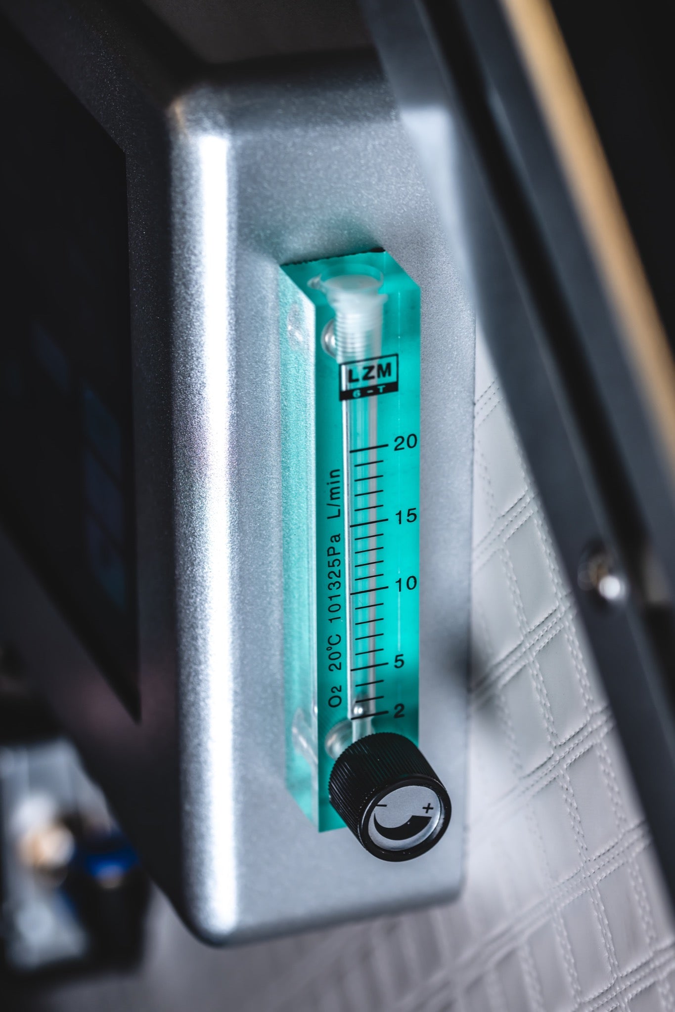 Close-up of an adjustable oxygen flow meter inside a hard-shell hyperbaric chamber.