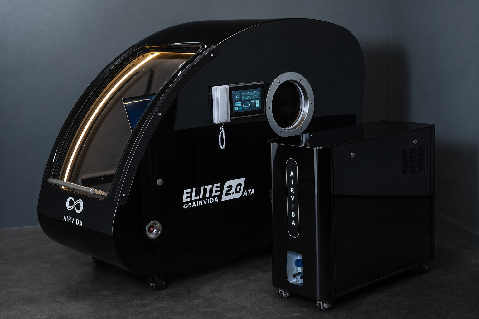 Airvida Elite 2.0 ATA hard-shell hyperbaric chamber with touchscreen controls and matching oxygen system unit.