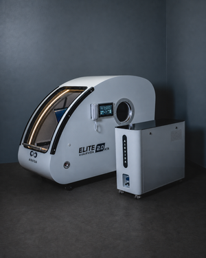 AIRVIDA Elite 2.0 ATA hard-shell hyperbaric chamber with a touchscreen, round viewing port, illuminated door, and separate oxygen system.