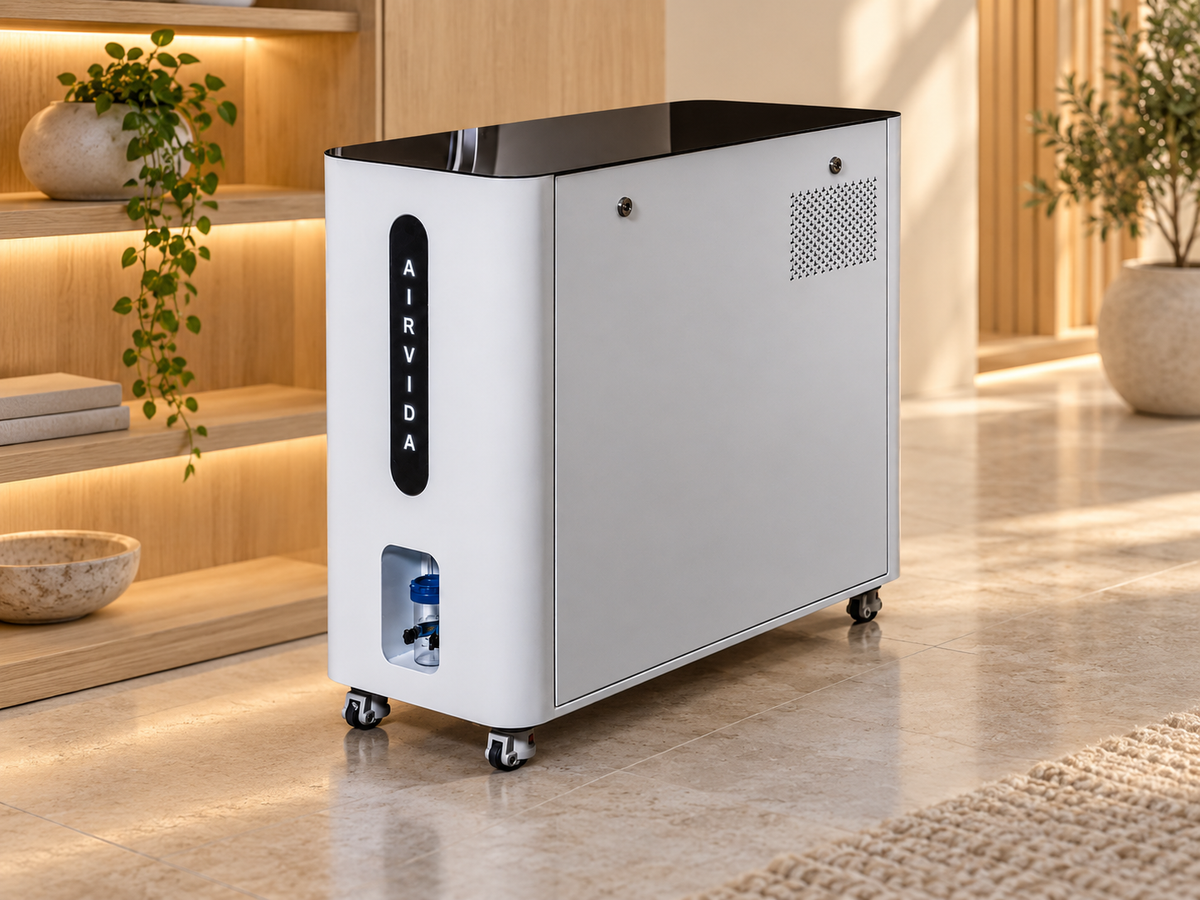 White Airvida oxygen system on caster wheels with black top, illuminated logo and front connector, displayed in a warm modern wellness room with wood and plants.