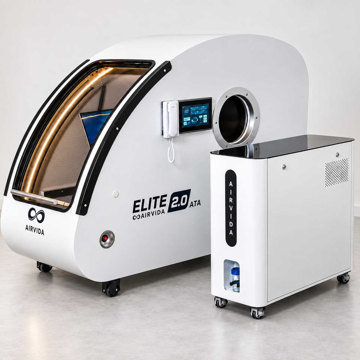 White Airvida Elite 2.0 ATA hyperbaric chamber with touchscreen, round access port and matching oxygen unit on wheels, presented in a clean clinical setting.