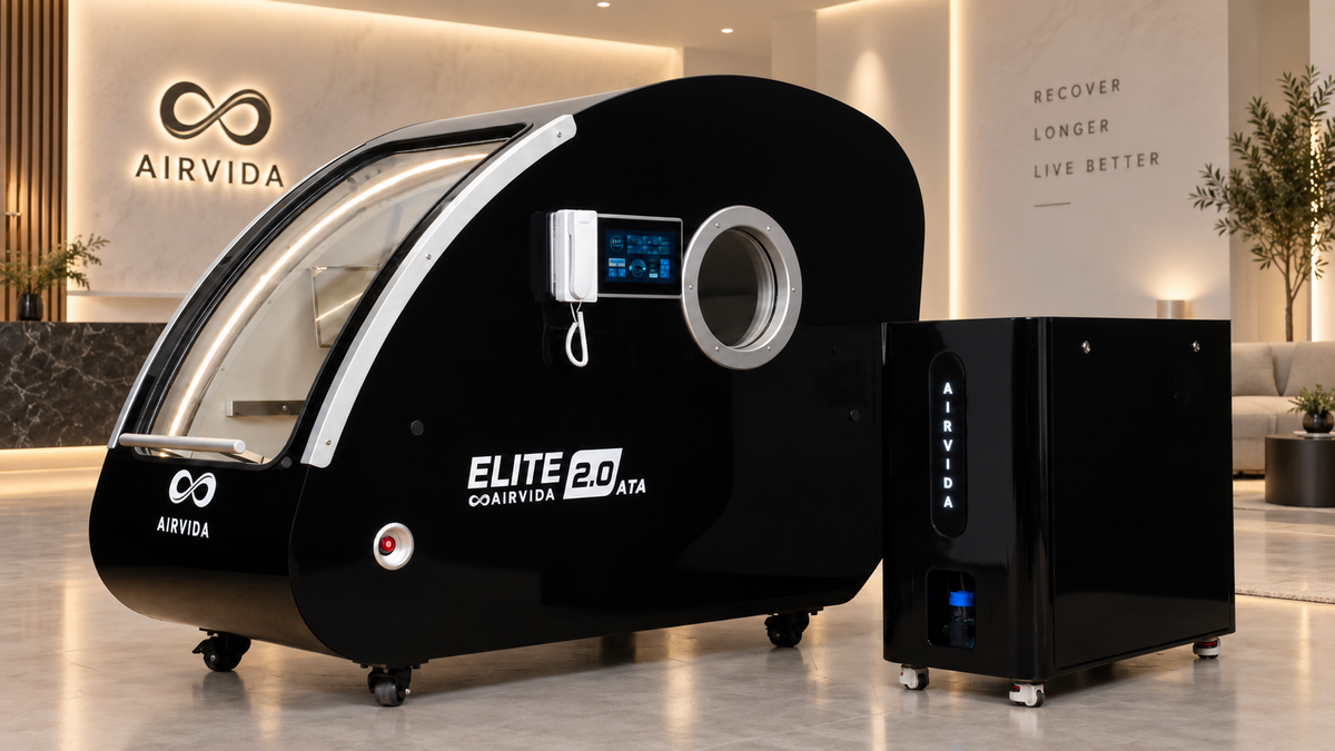 Black Airvida Elite 2.0 hyperbaric chamber with matching oxygen system displayed in a luxury wellness room with warm lighting, modern decor, and Airvida branding.